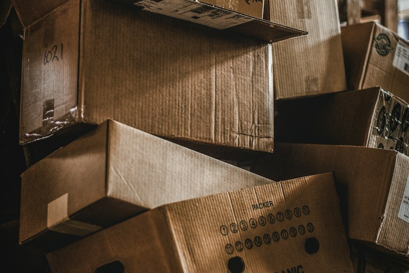 Cardboard moving boxes piled up in a storage area