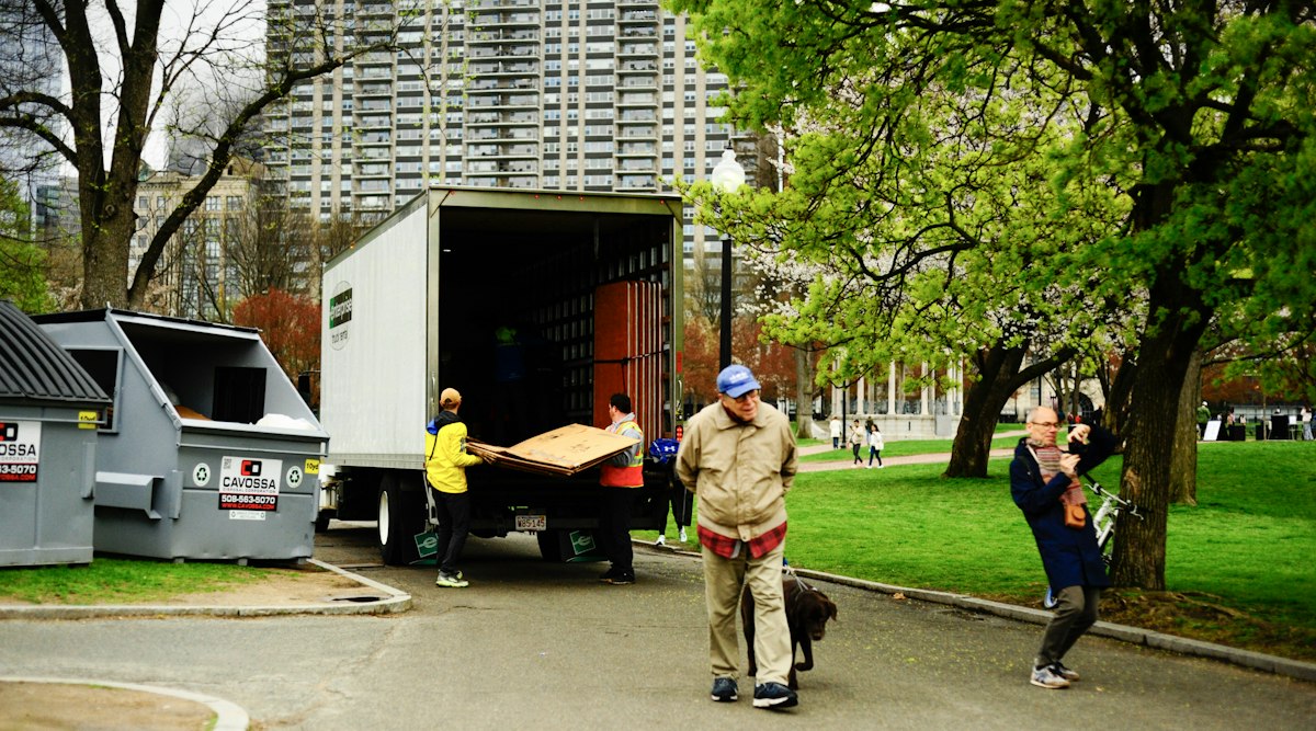 Workers loading furniture and boxes into a moving truck